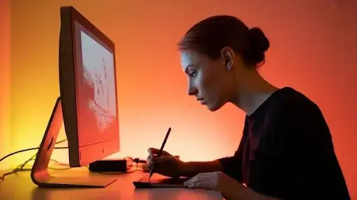 A female animator working on 2D art using modern software technology A female animator working on 2D art using modern software technology