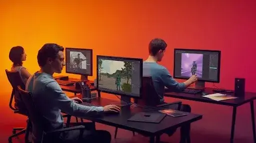 Professionals working on game projects Professionals working on game projects